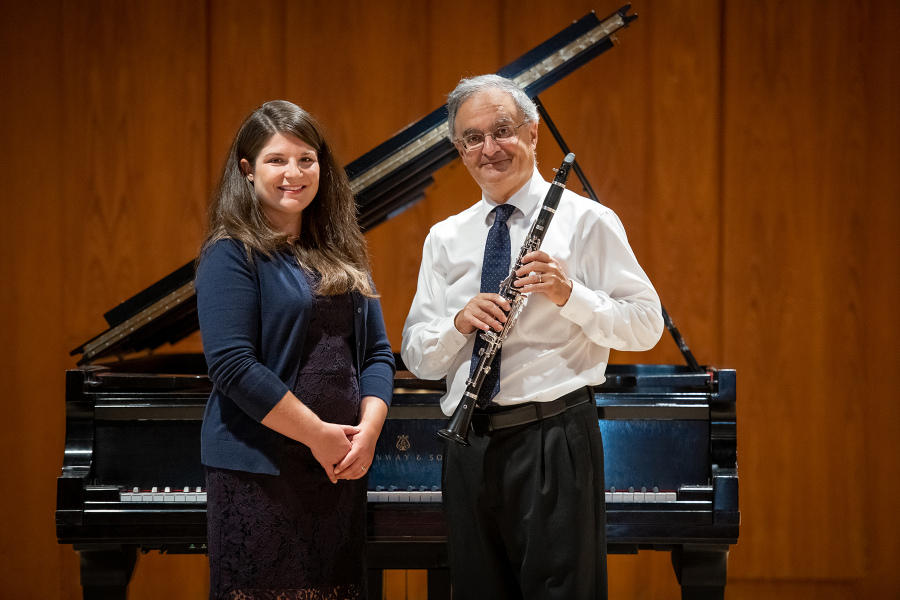 Magdalena von Eccher and Karem J. Simon A smiling woman and a man holding a clarinet stand before a grand piano