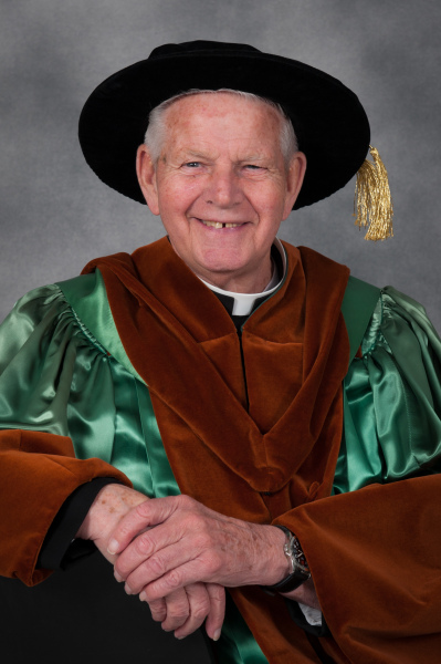 Father Charlie shown wearing his regalia during Convocation in 2015 when he was granted an honorary doctor of laws degree Photo of Fr. Charlie in his honorary doctorate regalia at Convocation 2015