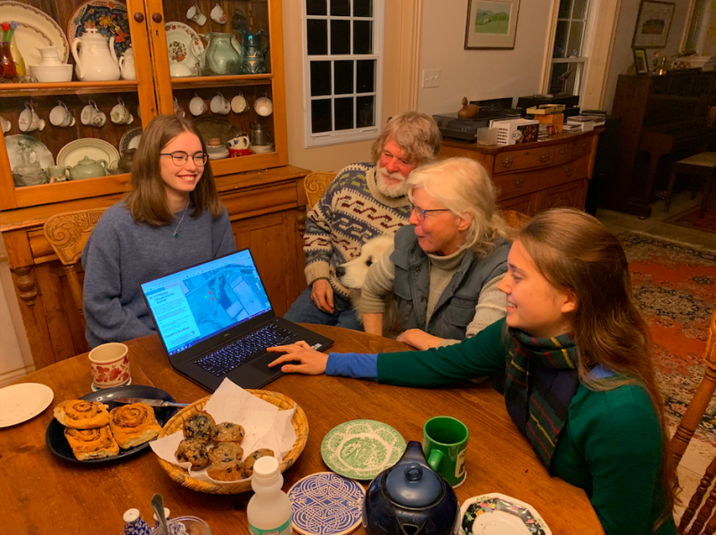Students Abigail Craswell and Alexandra Neumann gather information for the Back 50 project from Rusty Bittermann and Margaret McCallum, farmers at Rustaret Farm Two female students sit around a farm table speaking with an older couple
