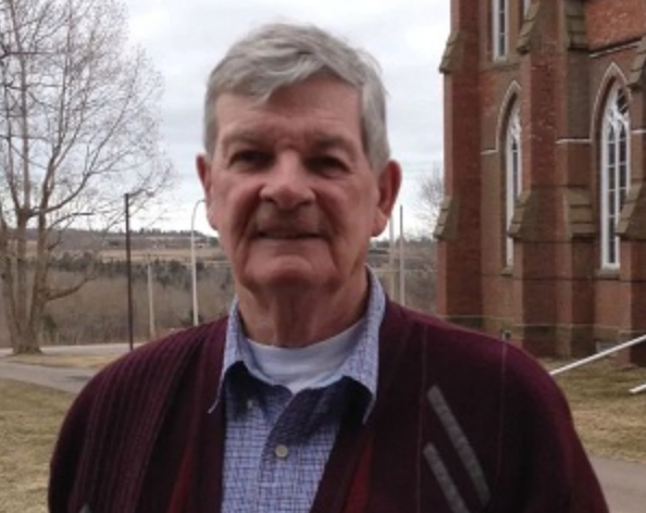 The late Rev. Gerard "Gerry" Tingley stands outside his last parish, St. Joachim's in Vernon River, PEI photo of Fr. Tingley
