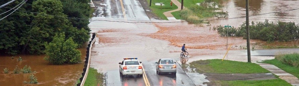 Photo by Don Jardine A river floods over a highway