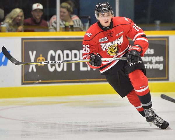 CHL photo A hockey player in a red and black uniform skates down the ice