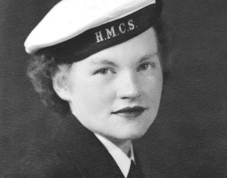 From the Jean Morley MacLean Collection A black and white close-up photo of a woman from the World War II era with a sailor's cap which reads HMCS on the band