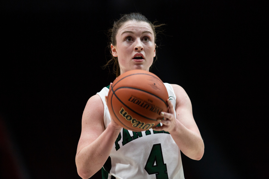 U SPORTS photo by Greg Mason A female basketball player in a green and white Panthers uniform concentrates on a free-throw attempt