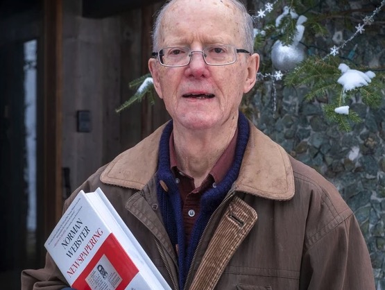 Chancellor Emeritus Norman Webster, seen in January 2021 with his book “Newspapering: 50 Years of Reporting from Canada and Around the World” PHOTO BY DAVE SIDAWAY/Montreal Gazette photo of man holding a book