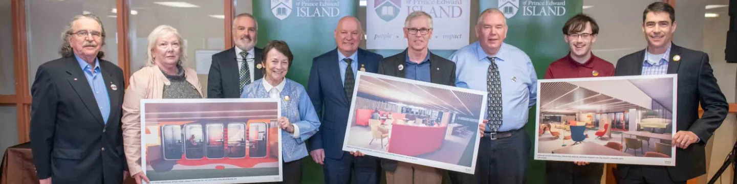nine people holding artist renderings of updated Library spaces